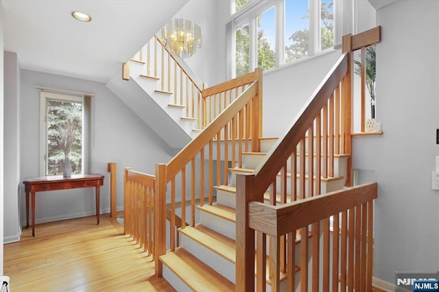 33 Willow Brk, North Caldwell, NJ 07006 - stairway with wood finished floors, a chandelier, recessed lighting, and baseboards