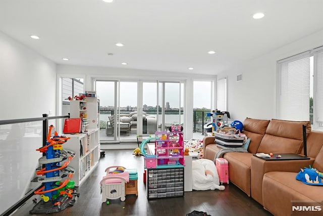 712 Undercliff Ave, Edgewater, NJ 07020 - living room with wood finished floors, recessed lighting, and a water view