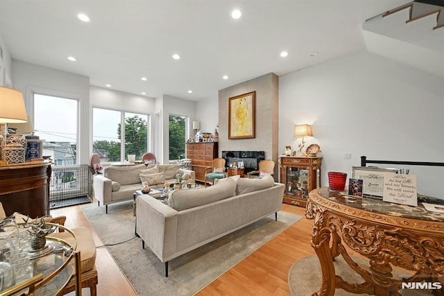 712 Undercliff Ave, Edgewater, NJ 07020 - living area with a multi sided fireplace, light wood-style flooring, and recessed lighting