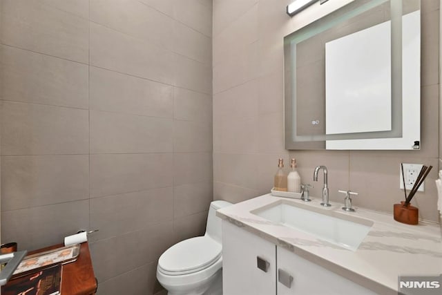 712 Undercliff Ave, Edgewater, NJ 07020 - bathroom featuring tile walls, vanity, and toilet