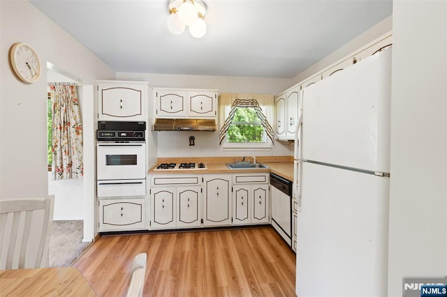 30 Fox Hill Rd, Fairfield, NJ 07004 - kitchen featuring white appliances, a warming drawer, a sink, light countertops, and light wood-style flooring