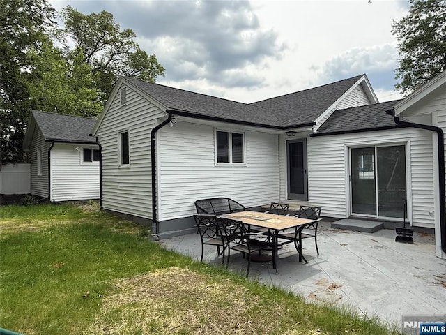 41 Woods Ave, Bergenfield, NJ 07621 - back of house with roof with shingles, a lawn, and a patio area