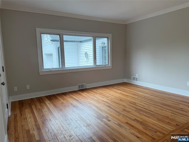 41 Woods Ave, Bergenfield, NJ 07621 - empty room with light wood-style flooring, ornamental molding, and baseboards