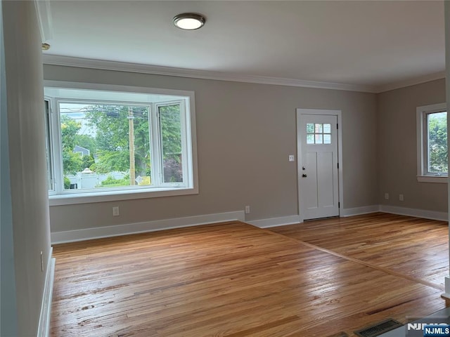 41 Woods Ave, Bergenfield, NJ 07621 - foyer entrance featuring light wood finished floors, crown molding, and baseboards