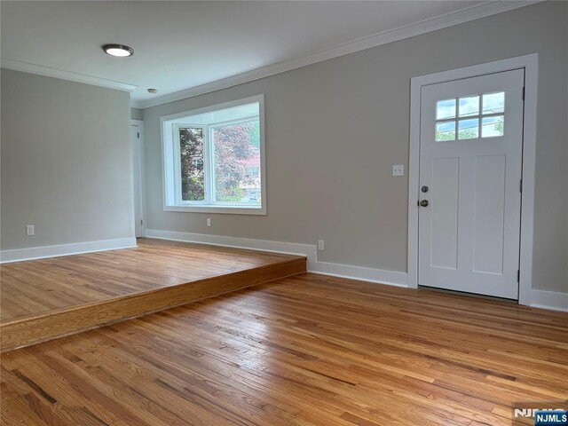 41 Woods Ave, Bergenfield, NJ 07621 - foyer entrance with ornamental molding, healthy amount of natural light, light wood-style floors, and baseboards