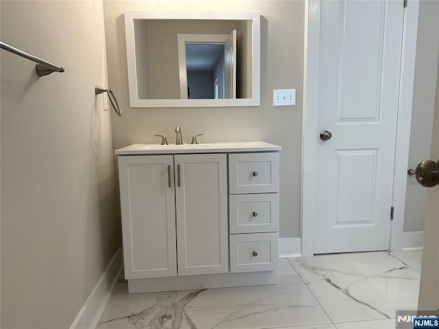 41 Woods Ave, Bergenfield, NJ 07621 - bathroom featuring marble finish floors, vanity, and baseboards