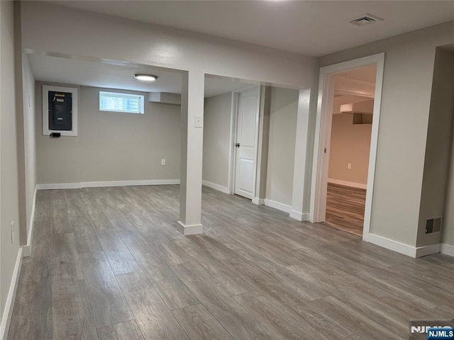 41 Woods Ave, Bergenfield, NJ 07621 - basement featuring wood finished floors, electric panel, and baseboards