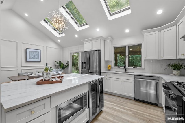 104 Myrtle Ave, Ramsey, NJ 07446 - kitchen with appliances with stainless steel finishes, a skylight, wine cooler, white cabinetry, and recessed lighting