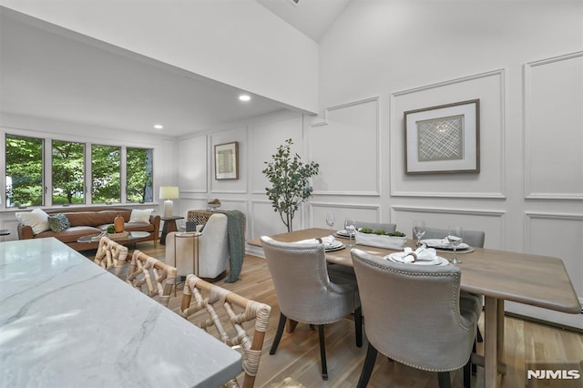 104 Myrtle Ave, Ramsey, NJ 07446 - dining space featuring a decorative wall, light wood finished floors, and high vaulted ceiling