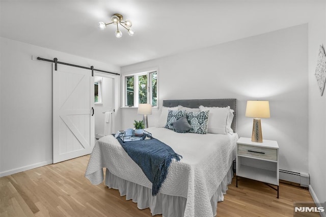 104 Myrtle Ave, Ramsey, NJ 07446 - bedroom featuring baseboard heating, a barn door, and wood finished floors