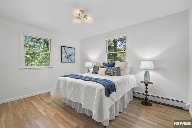 104 Myrtle Ave, Ramsey, NJ 07446 - bedroom with a baseboard radiator and wood finished floors