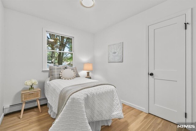 104 Myrtle Ave, Ramsey, NJ 07446 - bedroom with a baseboard radiator and light wood finished floors