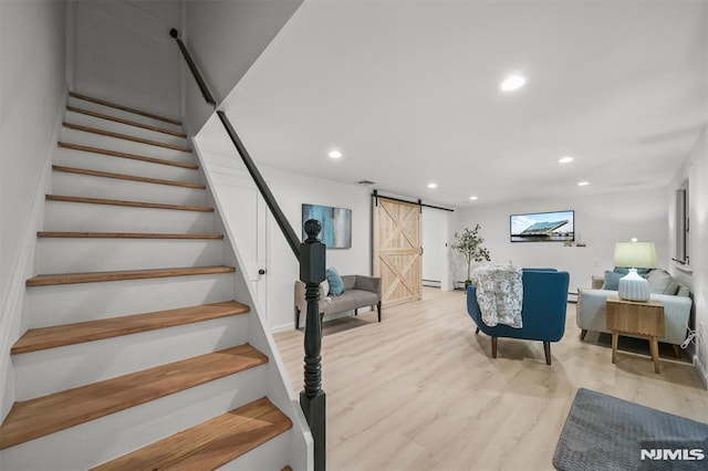 104 Myrtle Ave, Ramsey, NJ 07446 - stairway featuring a barn door, recessed lighting, wood finished floors, and a baseboard heating unit