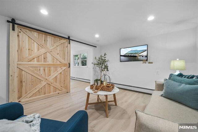 104 Myrtle Ave, Ramsey, NJ 07446 - living room with a baseboard heating unit, a barn door, light wood-style flooring, and recessed lighting