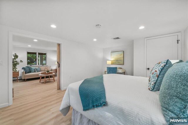 104 Myrtle Ave, Ramsey, NJ 07446 - bedroom with light wood-style flooring, recessed lighting, and a baseboard heating unit