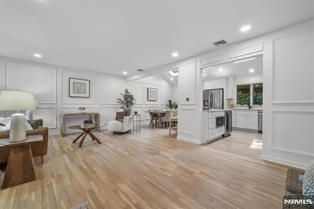 104 Myrtle Ave, Ramsey, NJ 07446 - living room with a decorative wall, recessed lighting, and light wood-style floors
