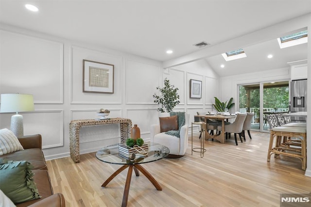 104 Myrtle Ave, Ramsey, NJ 07446 - living room with a decorative wall, a skylight, light wood finished floors, lofted ceiling, and recessed lighting