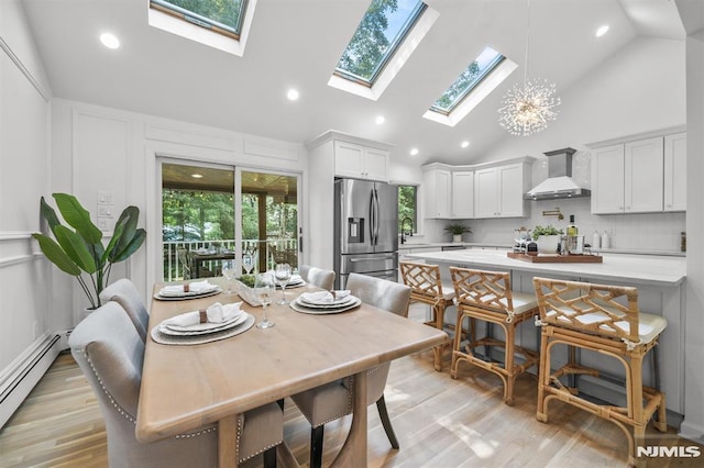 104 Myrtle Ave, Ramsey, NJ 07446 - dining space featuring a skylight, high vaulted ceiling, a baseboard heating unit, light wood finished floors, and recessed lighting
