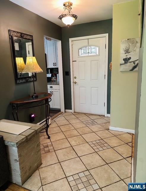 128 Up High Crest Rd, West Milford, NJ 07480 - entrance foyer with light tile patterned floors and baseboards