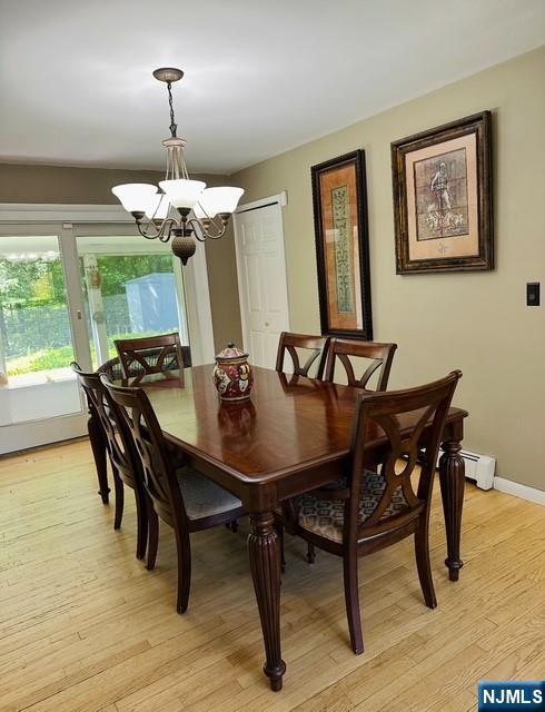 128 Up High Crest Rd, West Milford, NJ 07480 - dining space with a chandelier, light wood-style flooring, baseboards, and a baseboard radiator