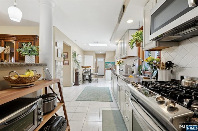 300 Wilson Ave, Lyndhurst, NJ 07071 - kitchen featuring appliances with stainless steel finishes, light tile patterned flooring, white cabinetry, tasteful backsplash, and recessed lighting