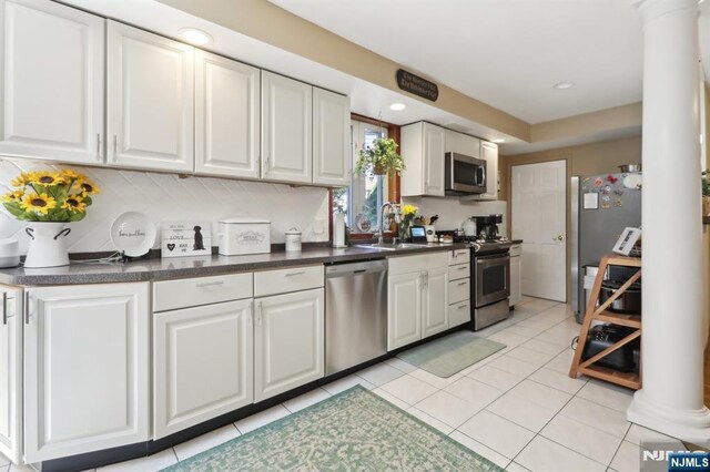300 Wilson Ave, Lyndhurst, NJ 07071 - kitchen featuring appliances with stainless steel finishes, a sink, ornate columns, white cabinets, and recessed lighting