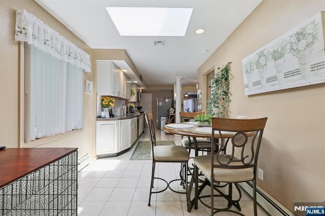 300 Wilson Ave, Lyndhurst, NJ 07071 - dining room featuring a skylight, light tile patterned floors, and a baseboard radiator