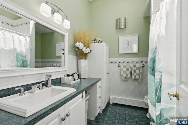 300 Wilson Ave, Lyndhurst, NJ 07071 - full bathroom with vanity, toilet, tile walls, a baseboard heating unit, and wainscoting