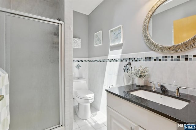 300 Wilson Ave, Lyndhurst, NJ 07071 - bathroom with tile walls, vanity, a shower stall, and toilet