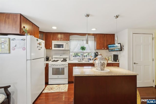 300 Wilson Ave, Lyndhurst, NJ 07071 - kitchen with white appliances, a sink, decorative backsplash, dark wood-style flooring, and pendant lighting