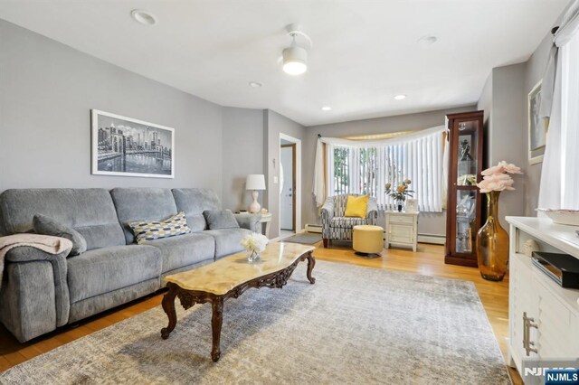 300 Wilson Ave, Lyndhurst, NJ 07071 - living room featuring light wood-type flooring, a baseboard heating unit, and recessed lighting