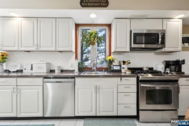 300 Wilson Ave, Lyndhurst, NJ 07071 - kitchen with appliances with stainless steel finishes, white cabinets, a sink, and dark countertops