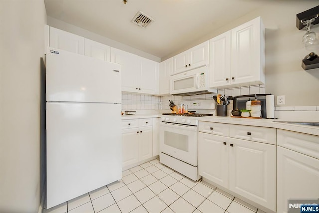 101 Royal Ave Unit 40, Hawthorne, NJ 07506 - kitchen with white appliances, white cabinets, backsplash, and light countertops