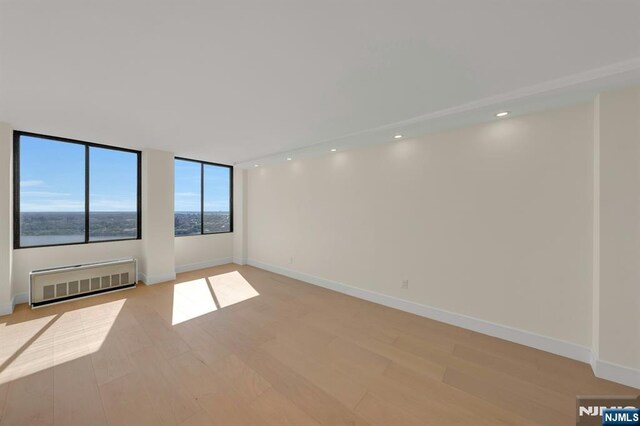 200 Winston Unit 2912, Cliffside Park, NJ 07010 - spare room featuring radiator heating unit, light wood finished floors, baseboards, and recessed lighting