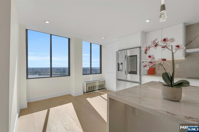 200 Winston Unit 2912, Cliffside Park, NJ 07010 - kitchen with stainless steel fridge, white cabinets, light wood finished floors, recessed lighting, and modern cabinets