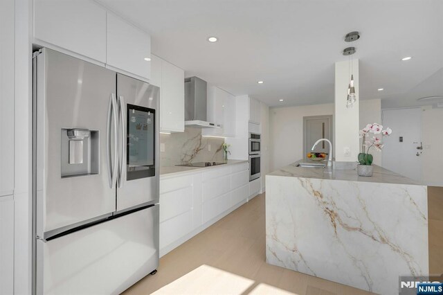 200 Winston Unit 2912, Cliffside Park, NJ 07010 - kitchen featuring appliances with stainless steel finishes, wall chimney exhaust hood, a sink, modern cabinets, and white cabinetry