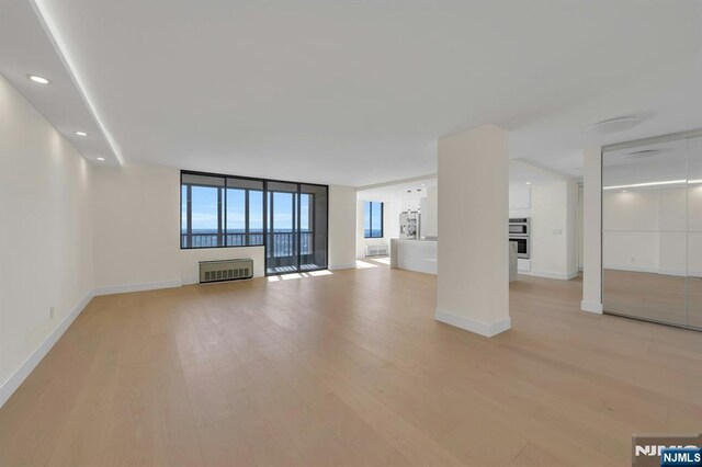 200 Winston Unit 2912, Cliffside Park, NJ 07010 - unfurnished living room featuring light wood finished floors, baseboards, recessed lighting, and a fireplace