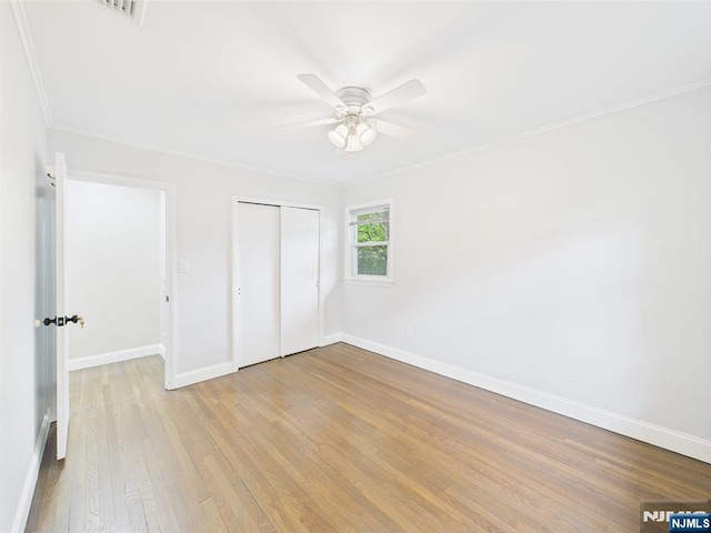 440 Albin Ct, Ridgewood, NJ 07450 - unfurnished bedroom with crown molding, baseboards, light wood-style flooring, a closet, and a ceiling fan
