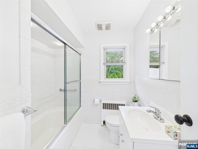 440 Albin Ct, Ridgewood, NJ 07450 - bathroom with radiator heating unit, tile walls, vanity, toilet, and tile patterned floors
