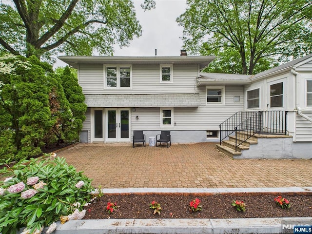 440 Albin Ct, Ridgewood, NJ 07450 - back of property with french doors, a chimney, and a patio area