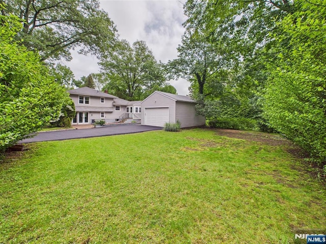 440 Albin Ct, Ridgewood, NJ 07450 - view of grassy yard featuring an outdoor structure, asphalt driveway, and a garage
