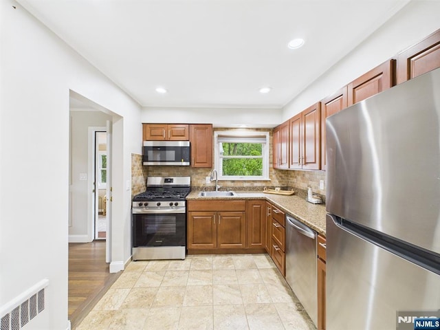 440 Albin Ct, Ridgewood, NJ 07450 - kitchen featuring stainless steel appliances, a sink, backsplash, light stone counters, and recessed lighting