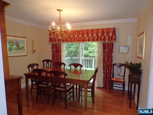 20 Carriage Ln, Ridgewood, NJ 07450 - dining area featuring crown molding, wood finished floors, a chandelier, and baseboards