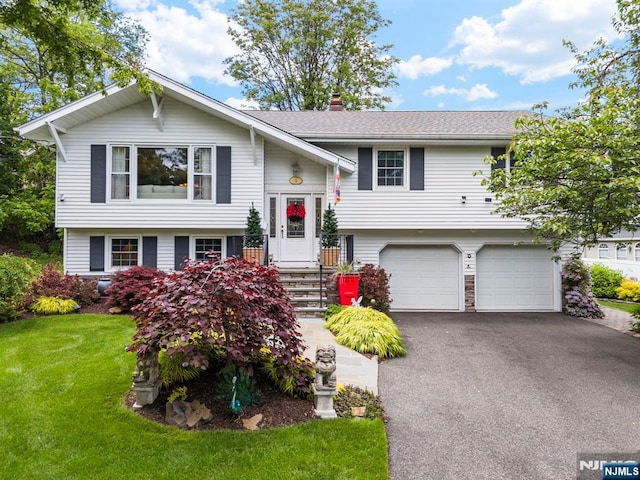 9 E Brook Dr, Paramus, NJ 07652 - split foyer home featuring a chimney, asphalt driveway, a garage, and a front lawn