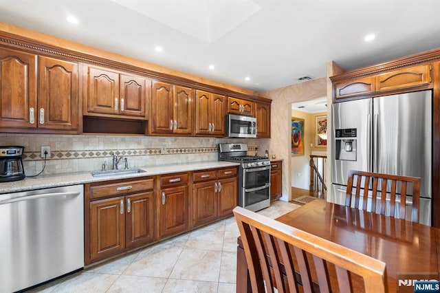 9 E Brook Dr, Paramus, NJ 07652 - kitchen with stainless steel appliances, a sink, decorative backsplash, recessed lighting, and light tile patterned flooring