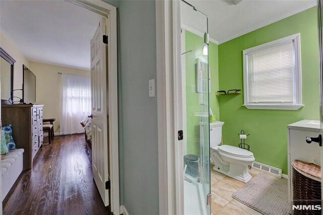 225 William St, River Vale, NJ 07675 - full bathroom with baseboards, a shower stall, toilet, crown molding, and wood finished floors