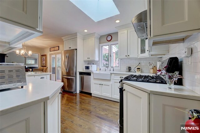 225 William St, River Vale, NJ 07675 - kitchen with appliances with stainless steel finishes, light countertops, tasteful backsplash, white cabinets, and recessed lighting