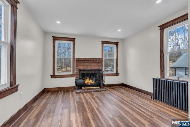 18 Edge Hill Rd, Blairstown, NJ 07825 - unfurnished living room featuring radiator, wood finished floors, plenty of natural light, baseboards, and recessed lighting