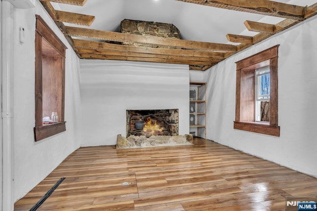 18 Edge Hill Rd, Blairstown, NJ 07825 - unfurnished living room with vaulted ceiling, wood finished floors, and a warm lit fireplace