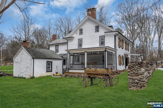 18 Edge Hill Rd, Blairstown, NJ 07825 - rear view of property with a chimney, a yard, and a sunroom
